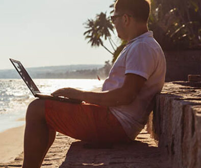 Man,On,Beach,With,Laptop,,Vietnam,,Mui,Ne