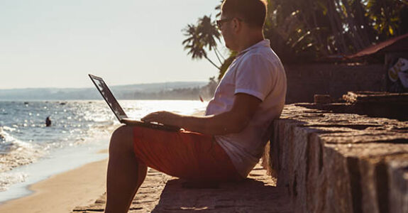 Man,On,Beach,With,Laptop,,Vietnam,,Mui,Ne